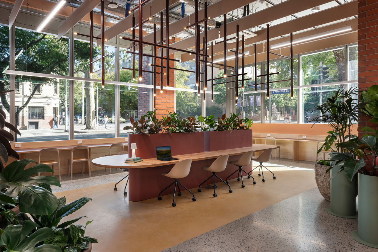 Curved desk in bright, modern workspace.