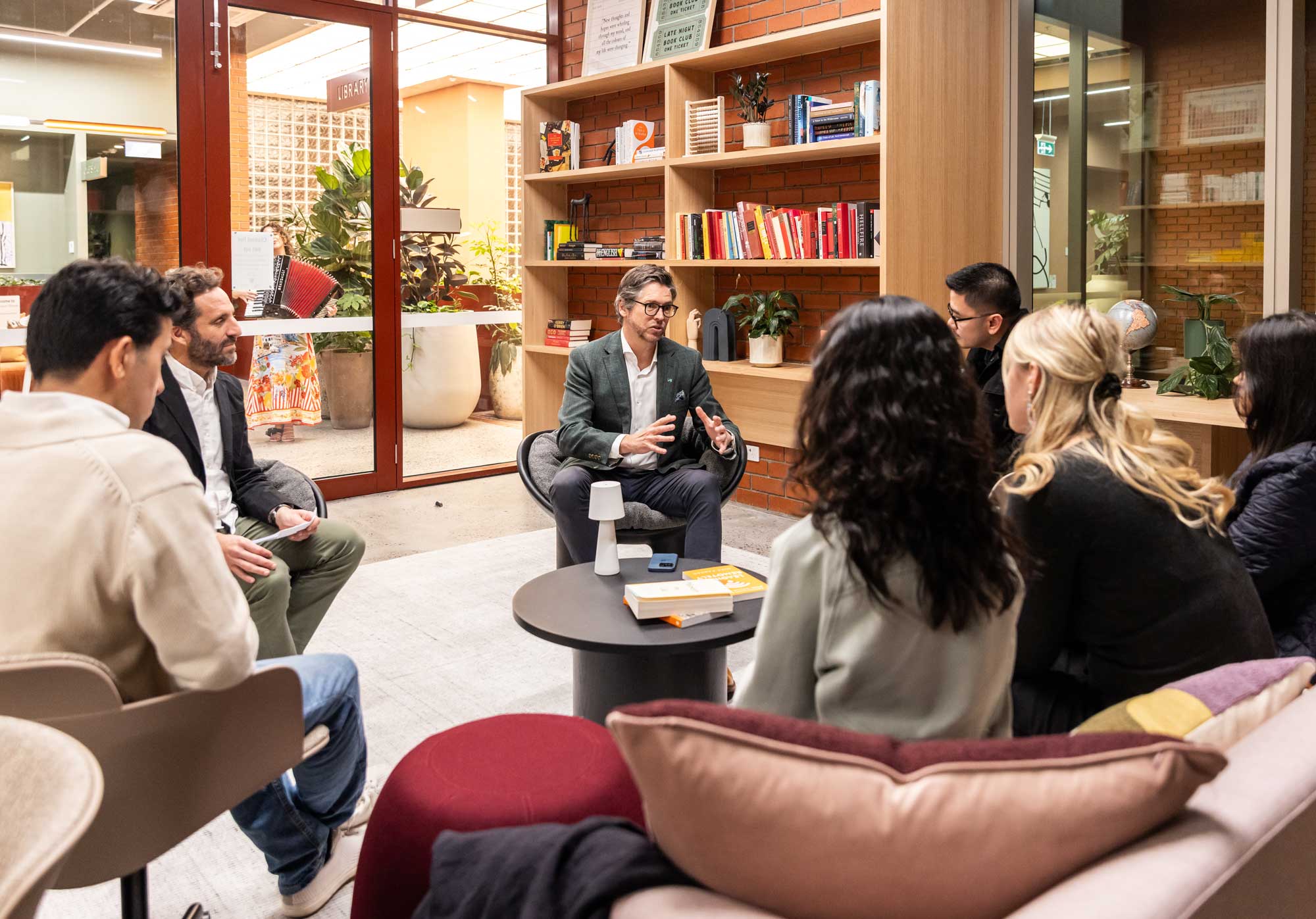 Group discussion around a table in a bright, modern room.